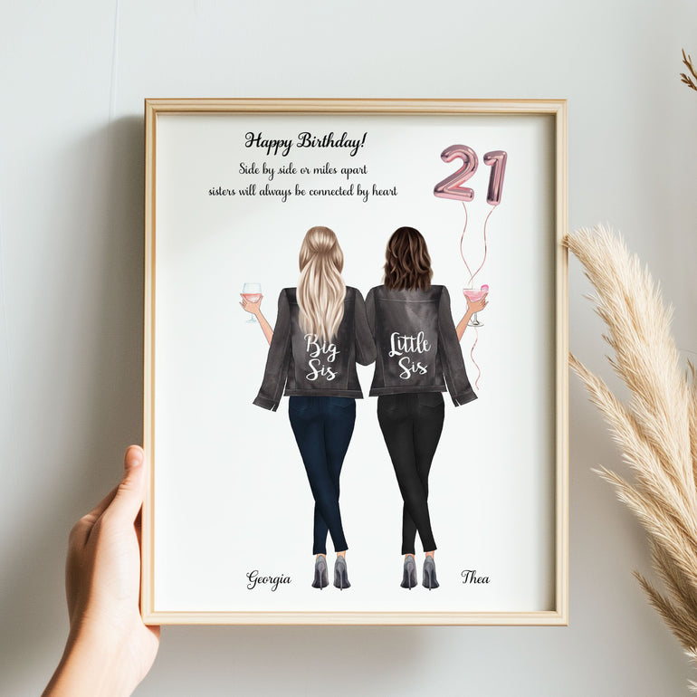 Framed artwork of two women with text and balloons, held by a hand on a light background.