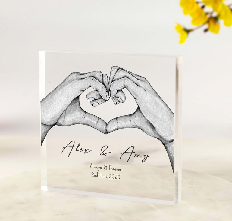 Personalised acrylic block featuring two hands forming a heart, with custom names, date, and wording like “Always & Forever” printed on clear acrylic.