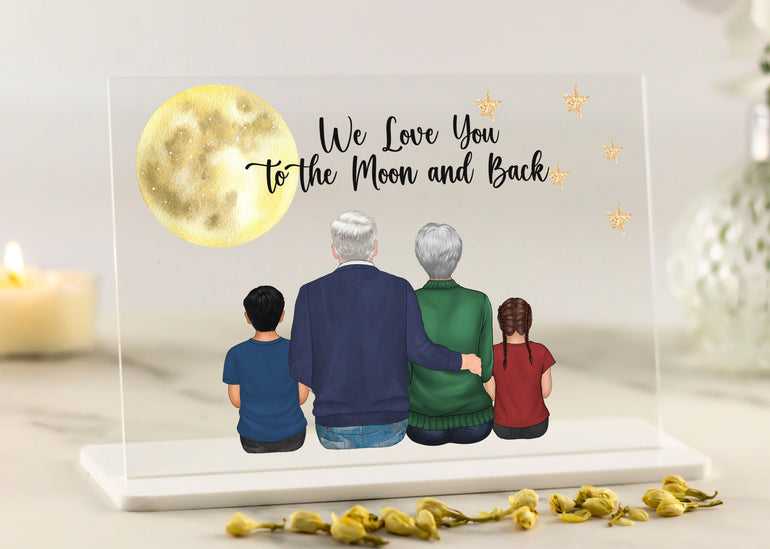 Decorative plaque with family illustration and 'We Love You to the Moon and Back' text on a light background.