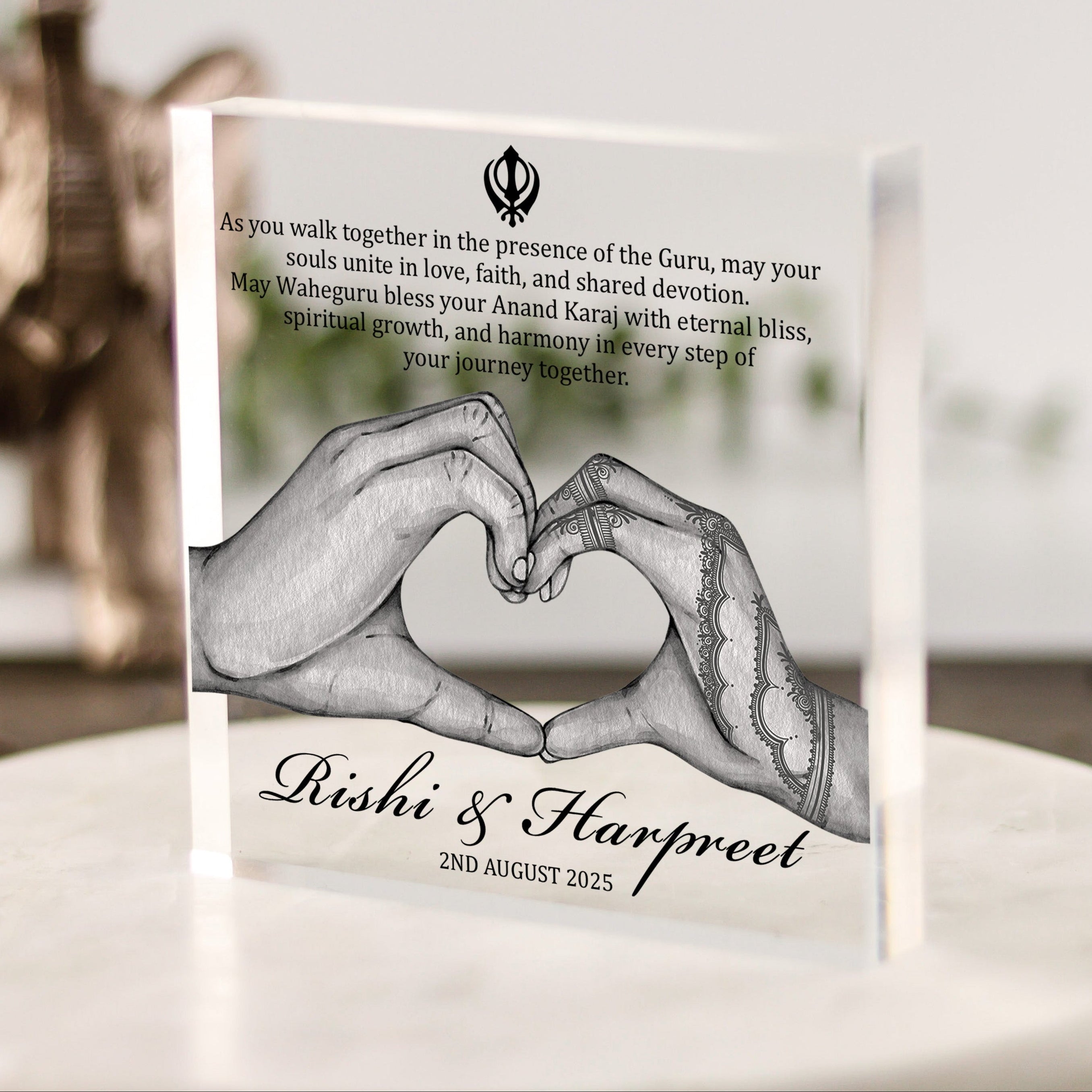 Personalised Sikh wedding acrylic block with hands forming heart, couple’s names, date, and Anand Karaj blessing quote in modern spiritual style.