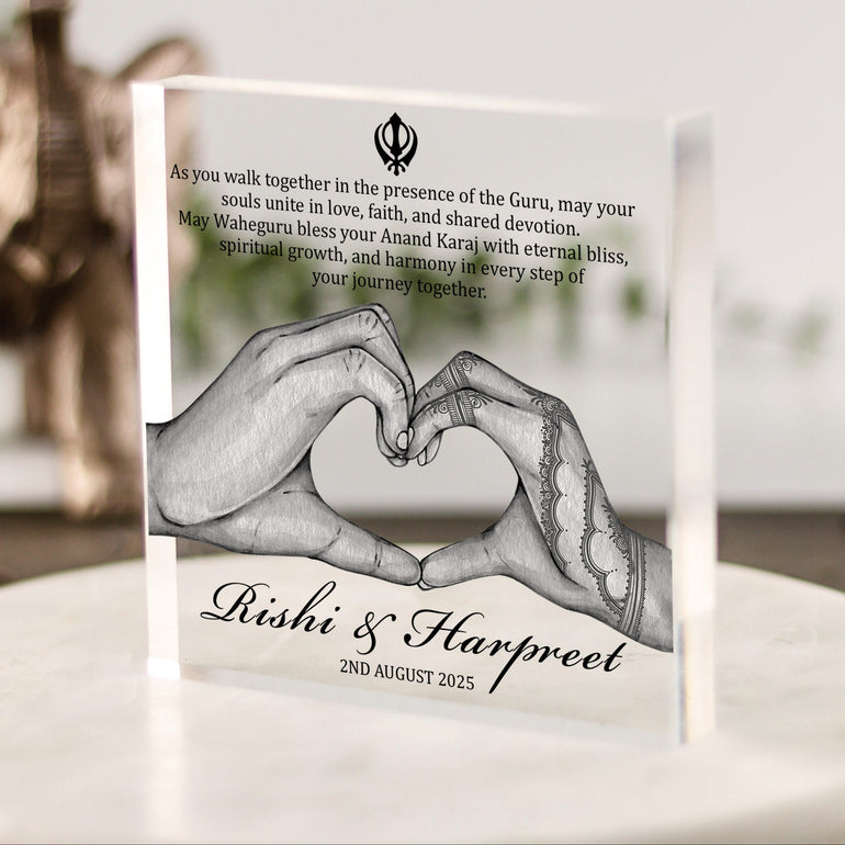 Personalised Sikh wedding acrylic block with hands forming heart, couple’s names, date, and Anand Karaj blessing quote in modern spiritual style.