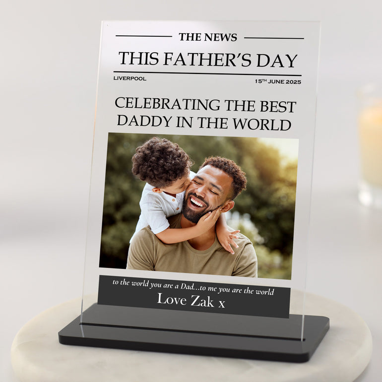 Personalised Father's Day newspaper style photo plaque with headline, dad and child photo, and custom message printed on clear acrylic with black base.