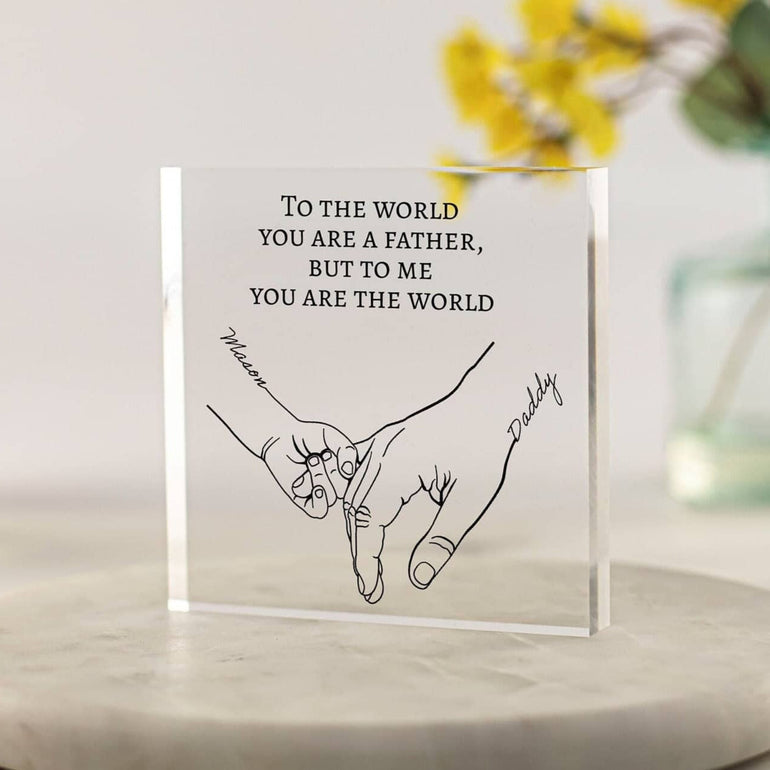Freestanding acrylic block with minimalist line art of baby holding father's finger and sentimental quote – personalised Father's Day gift from baby or child.