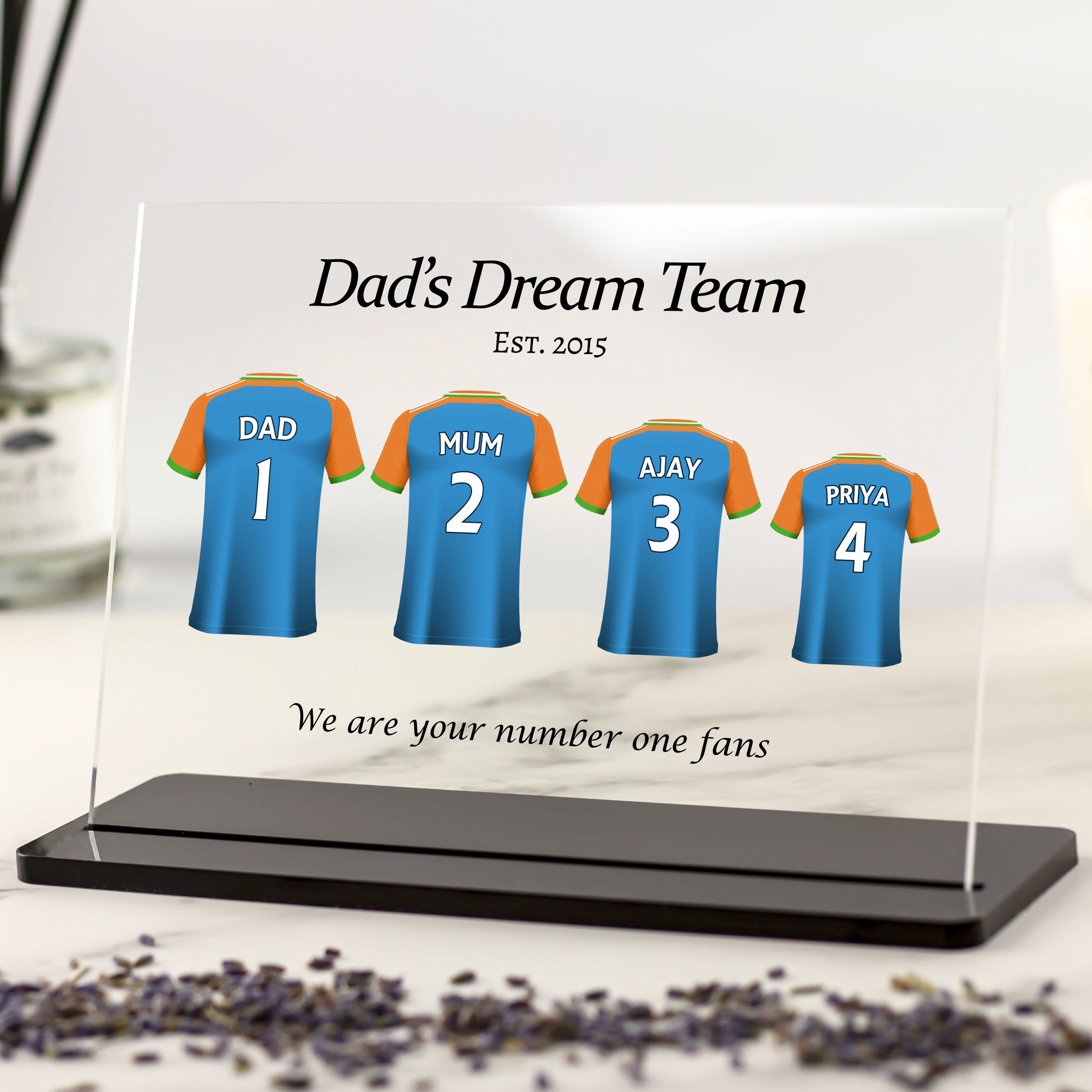 Personalised India cricket shirt acrylic plaque featuring custom names and numbers for family members, displayed as a gift for Dad on black stand.