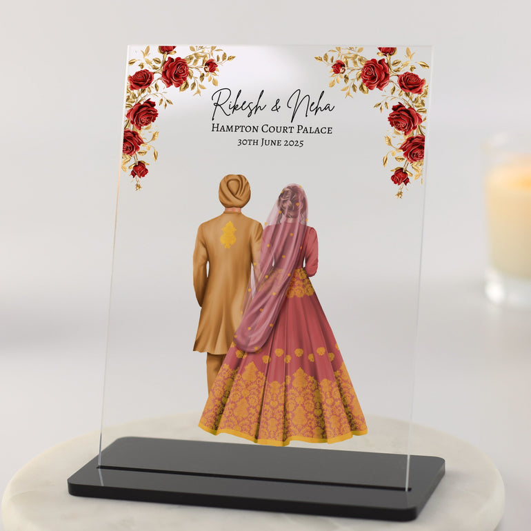 Personalised Indian wedding couple acrylic plaque with bride and groom illustration, floral border, names and wedding details in clear block format.
