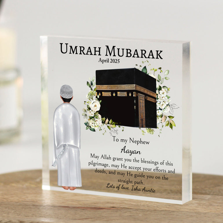 Personalised Umrah Mubarak acrylic gift block for a nephew, featuring the Kaaba with floral design and a boy in Ihram. Includes custom name and dua message.
