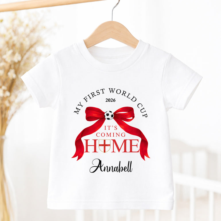 Personalised It’s Coming Home World Cup 2026 baby T-shirt with red bow and child’s name