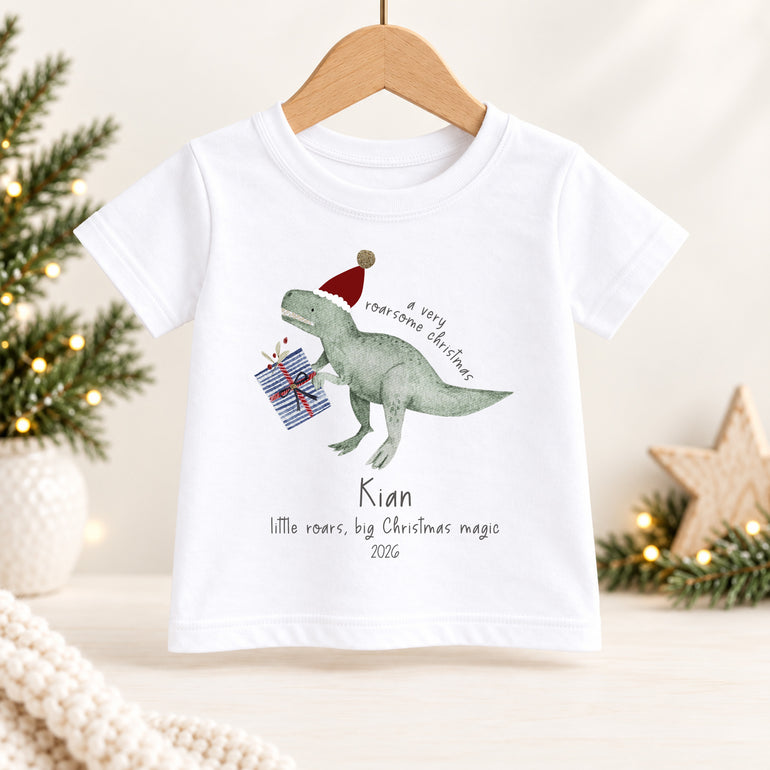 Personalised dinosaur Christmas kids T-shirt with festive dinosaur, presents, child’s name and chosen year