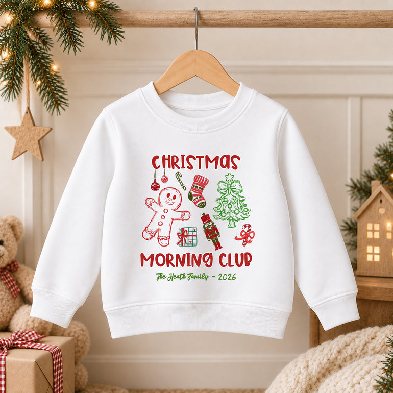 White family Christmas sweatshirt on a hanger reading Christmas Morning Club with a gingerbread man, nutcracker, stocking and tree, The Heath Family 2026
