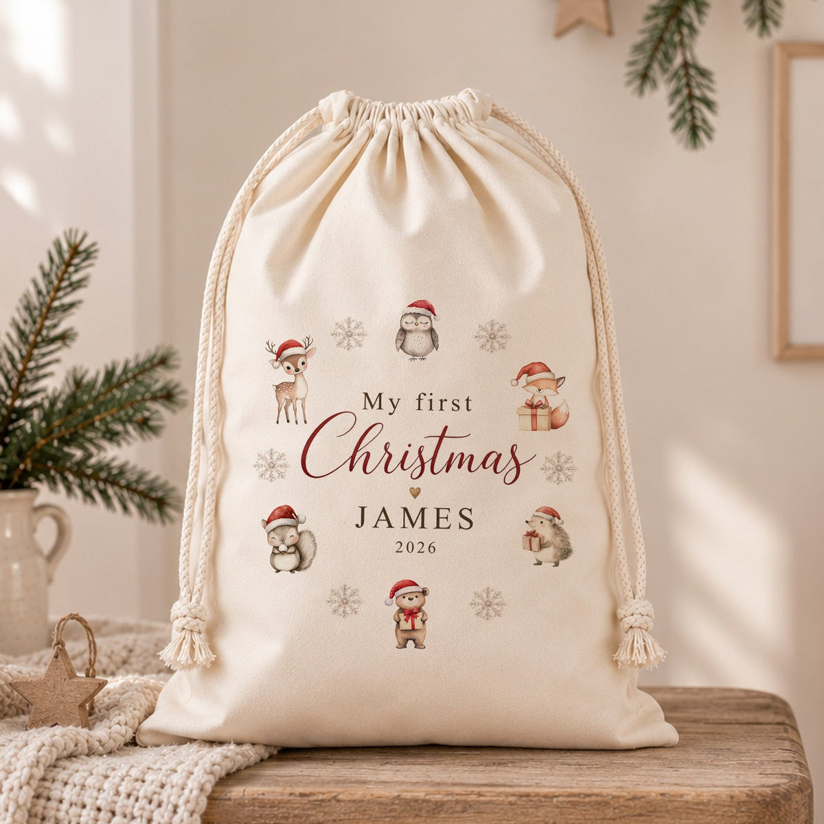 Personalised My First Christmas Santa sack with child’s name and year, featuring festive woodland animals in a neutral Christmas nursery setting.