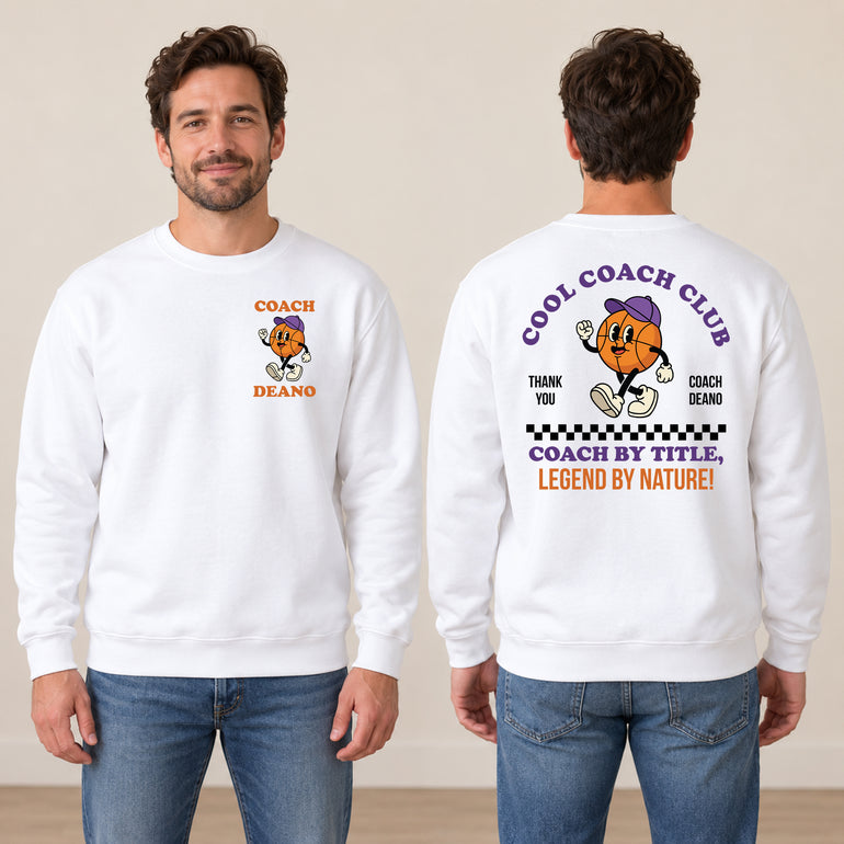 Man in a white Cool Coach Club basketball coach gift sweatshirt, the back printed with Cool Coach Club, a retro cartoon basketball character in a purple cap, Thank You, Coach Deano and Coach by Title, Legend by Nature, the front with a small Coach Deano badge