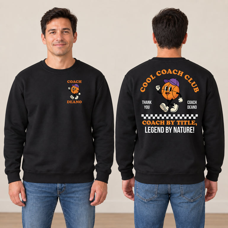 Man in a black Cool Coach Club basketball coach gift sweatshirt, the back printed with Cool Coach Club, a retro cartoon basketball character in a purple cap, Thank You, Coach Deano and Coach by Title, Legend by Nature, the front with a small Coach Deano badge