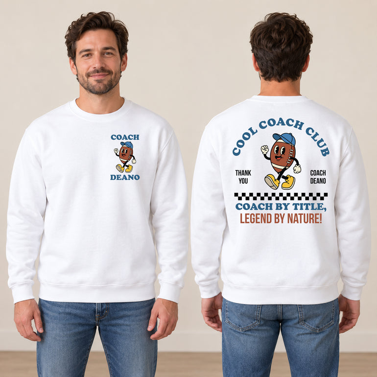Man in a white Cool Coach Club rugby coach gift sweatshirt, the back printed with Cool Coach Club, a retro cartoon rugby ball character in a blue cap, Thank You, Coach Deano and Coach by Title, Legend by Nature, the front with a small Coach Deano badge