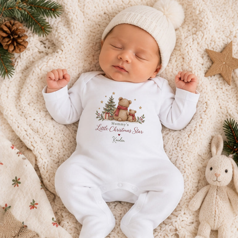 Newborn baby wearing personalised Mummy’s Little Christmas Star baby grow with festive teddy bear design and child’s name