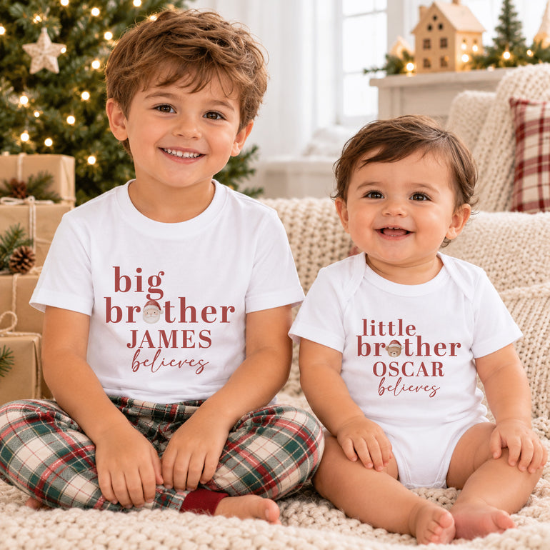 Big Brother and Little Brother wearing personalised matching Christmas clothing with names, Believes wording and Santa and teddy head designs
