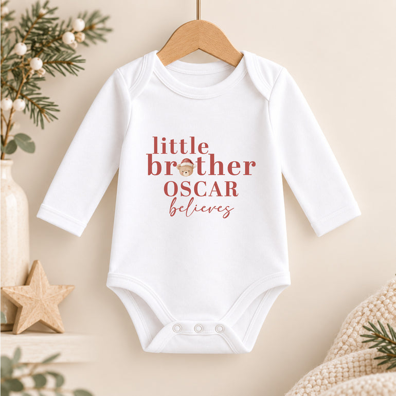 Personalised Little Brother Christmas baby vest with name Oscar, festive teddy head and red Believes wording
