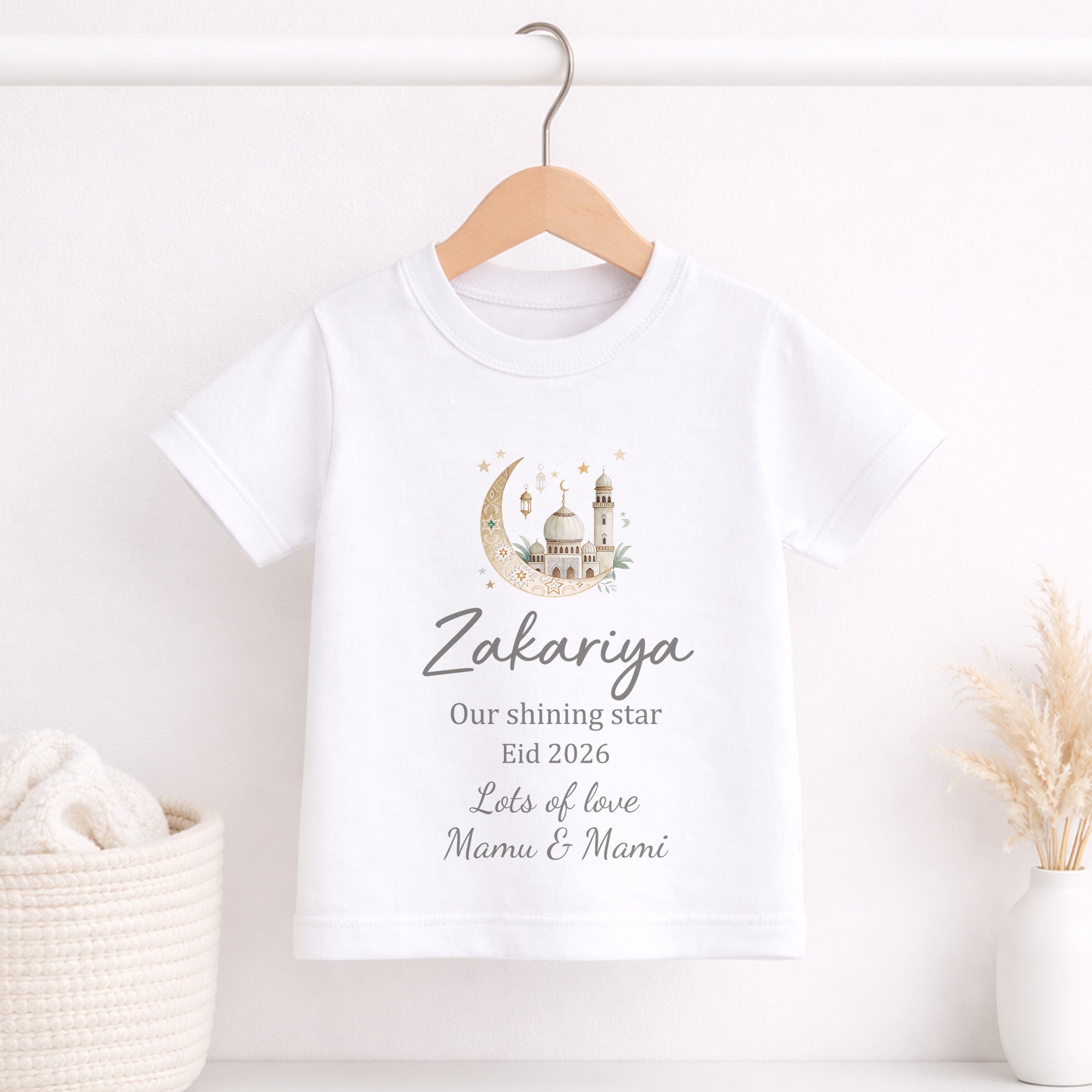 White t-shirt with personalized design and text on a wooden hanger against a white background