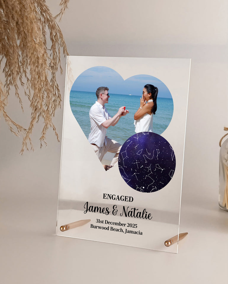 Personalised engagement acrylic plaque with photo and star map, displayed with metal rod fixings as a sentimental couple keepsake gift.
