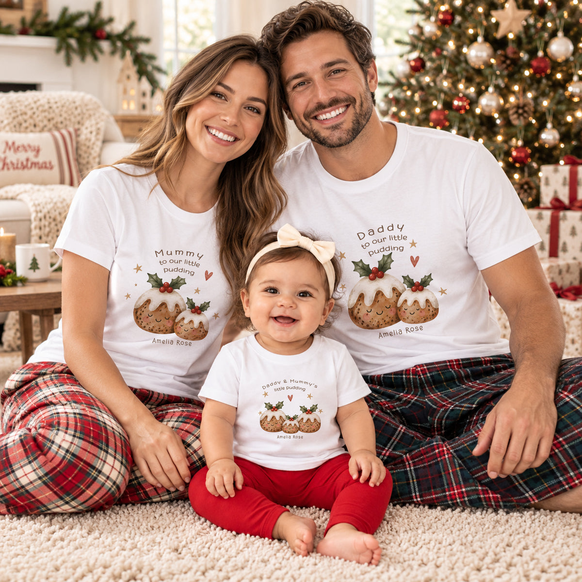 Mummy Daddy and child wearing personalised matching family Christmas shirts with festive pudding designs and child’s name
