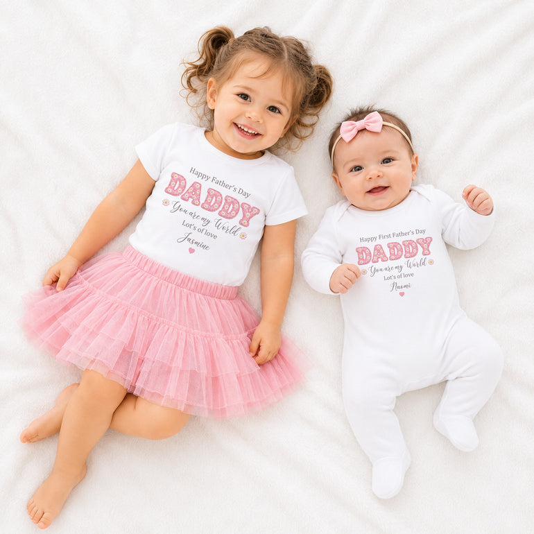 Matching baby and child outfits with personalised Daisy Daddy Father’s Day design and pink lettering.