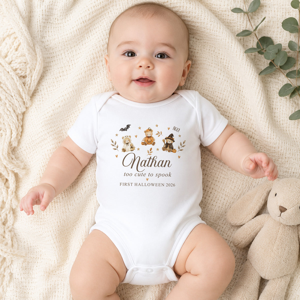 Baby wearing personalised Too Cute to Spook First Halloween baby vest with name