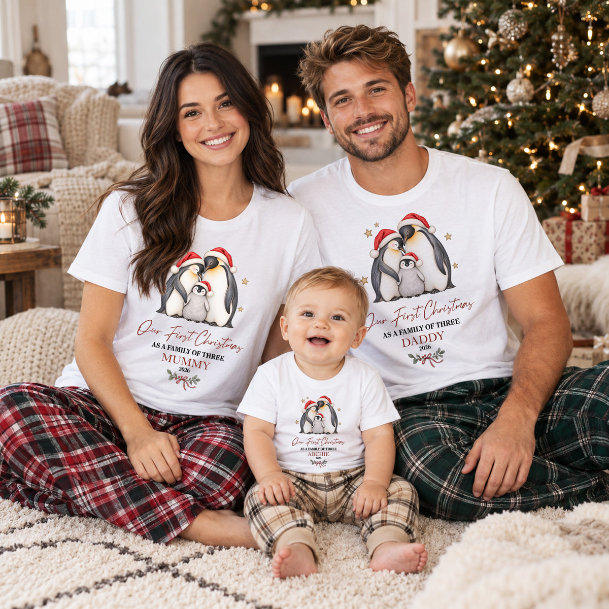 Family wearing personalised first Christmas family of three matching clothing with festive penguin design, names, Mummy and Daddy roles and custom year