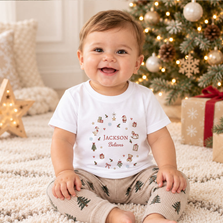 Child wearing personalised Believes Christmas T-shirt with festive illustrated design and custom name