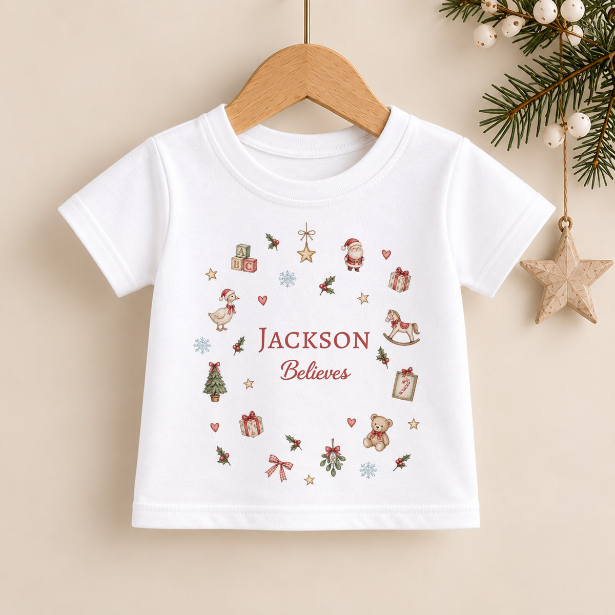 Personalised kids Christmas T-shirt with child’s name, Believes wording and miniature festive Christmas illustrations