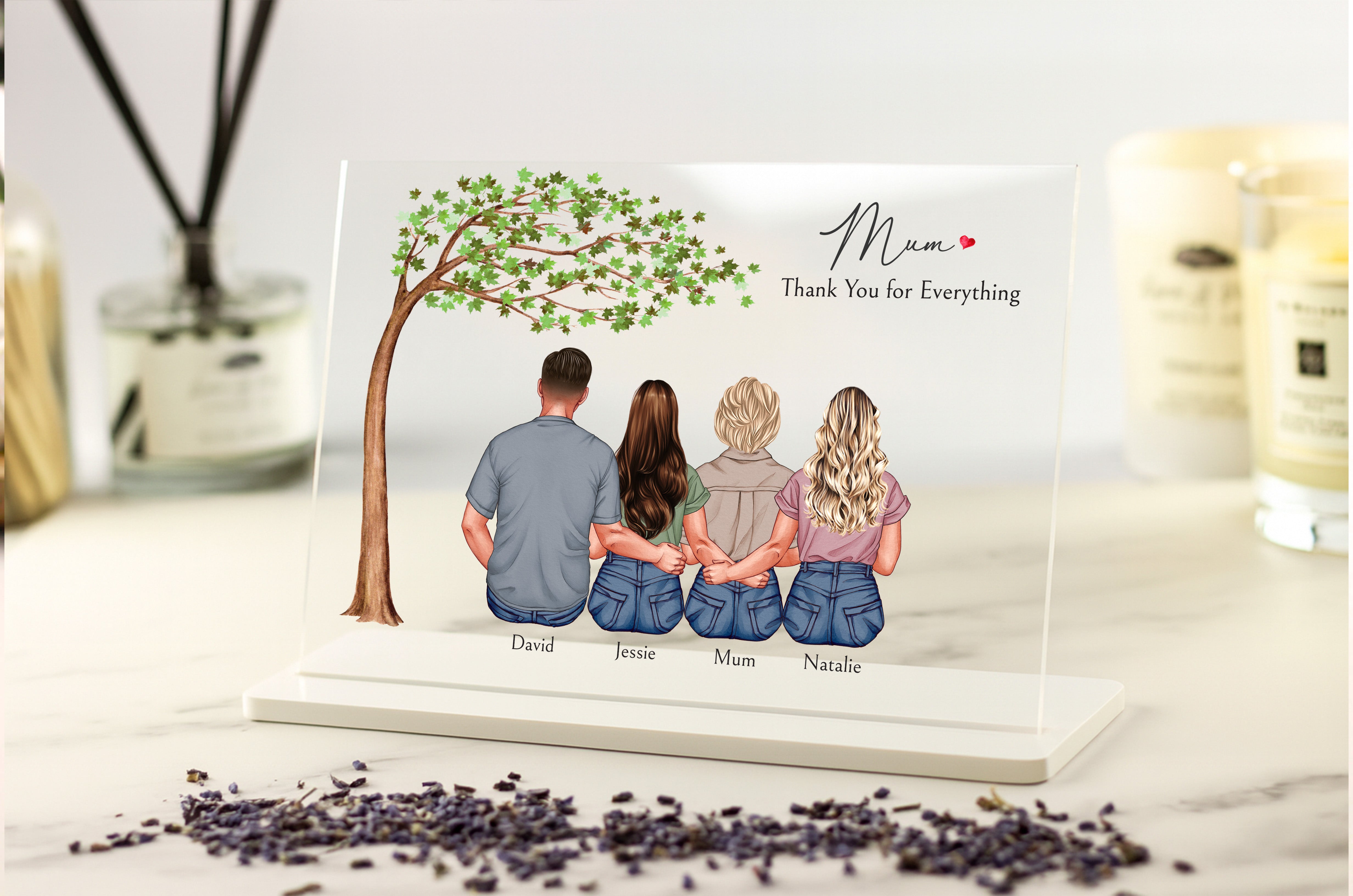 Personalized family portrait with four people sitting under a tree on a decorative card.