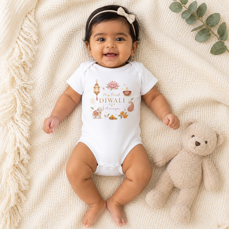 Baby girl wearing personalised My First Diwali vest with pink Diwali wreath