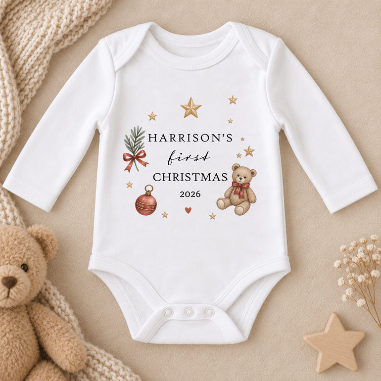 Personalised white First Christmas baby clothing with teddy bear, Christmas bauble, gold stars, child’s name and year.
