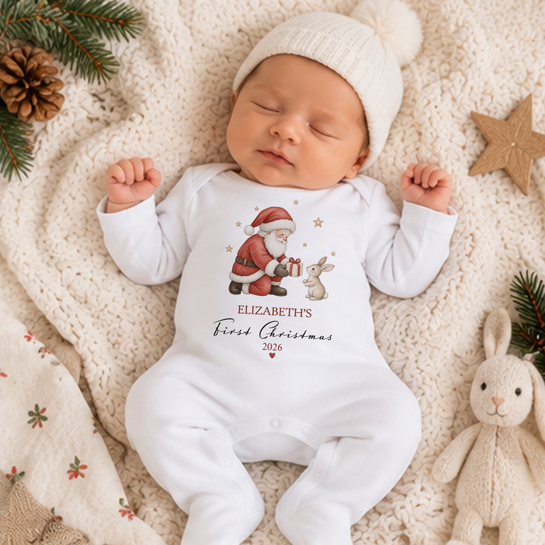Baby wearing personalised Santa and Bunny First Christmas baby grow with child’s name and Christmas year