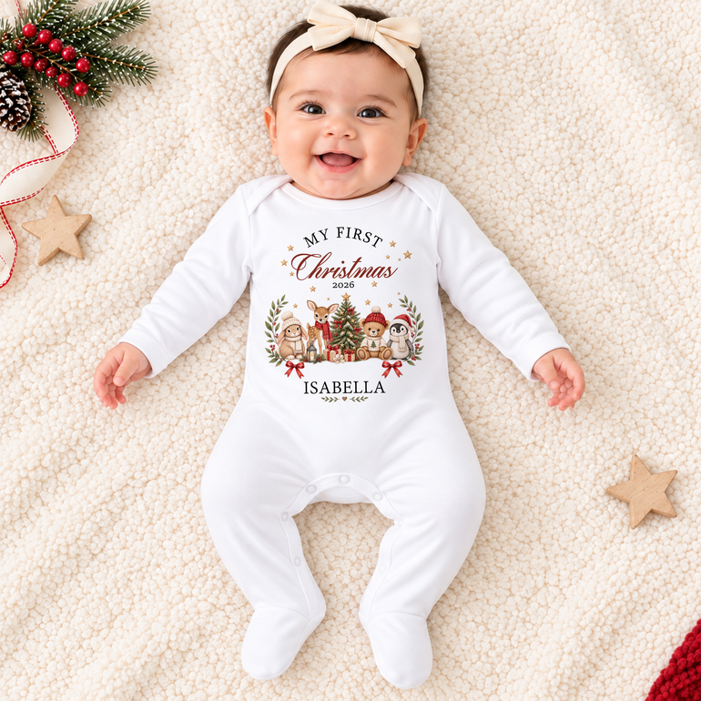 Baby wearing personalised Storybook Friends First Christmas baby grow with child’s name and Christmas year