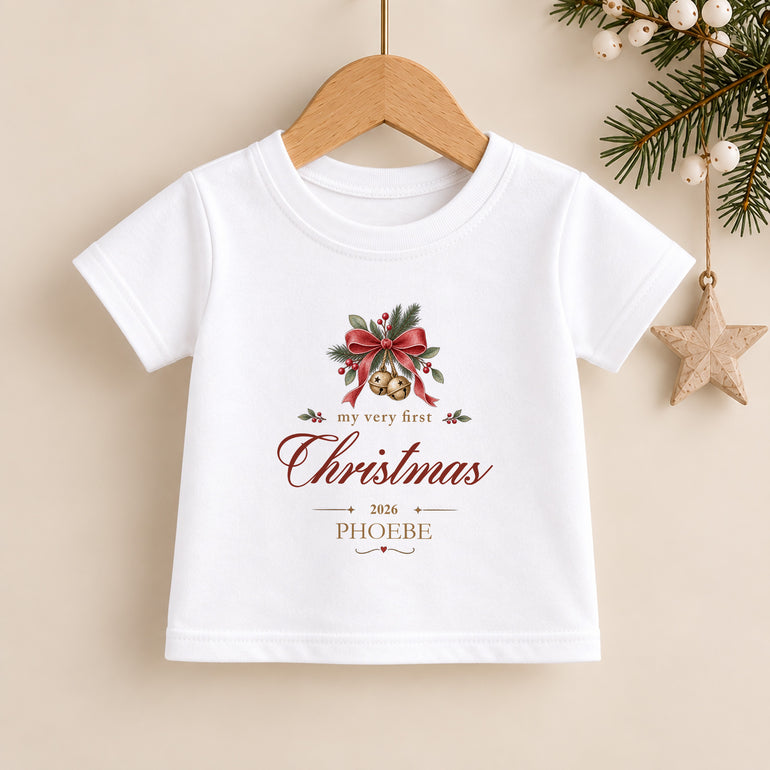 Personalised First Christmas kids T-shirt with Christmas bells, festive greenery, child’s name and chosen year