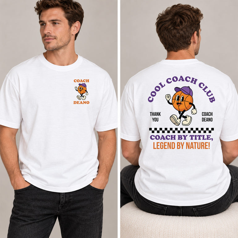 Man in a white Cool Coach Club basketball coach gift T-shirt, the back printed with Cool Coach Club, a retro cartoon basketball character in a purple cap, Thank You, Coach Deano and Coach by Title, Legend by Nature, the front with a small Coach Deano badge