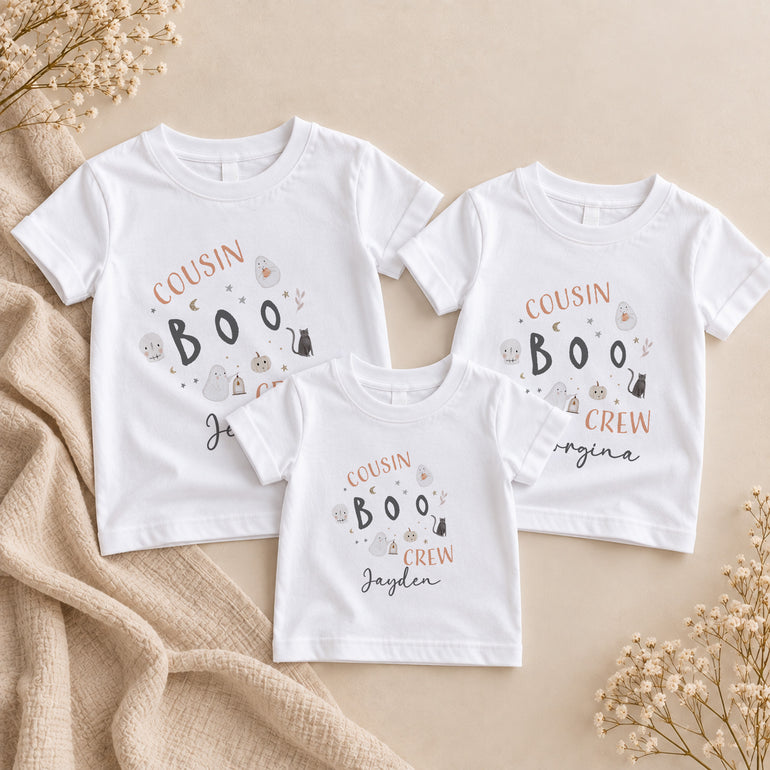 Three personalised matching Cousin Boo Crew Halloween T-shirts for kids with individual names and illustrated spooky motifs