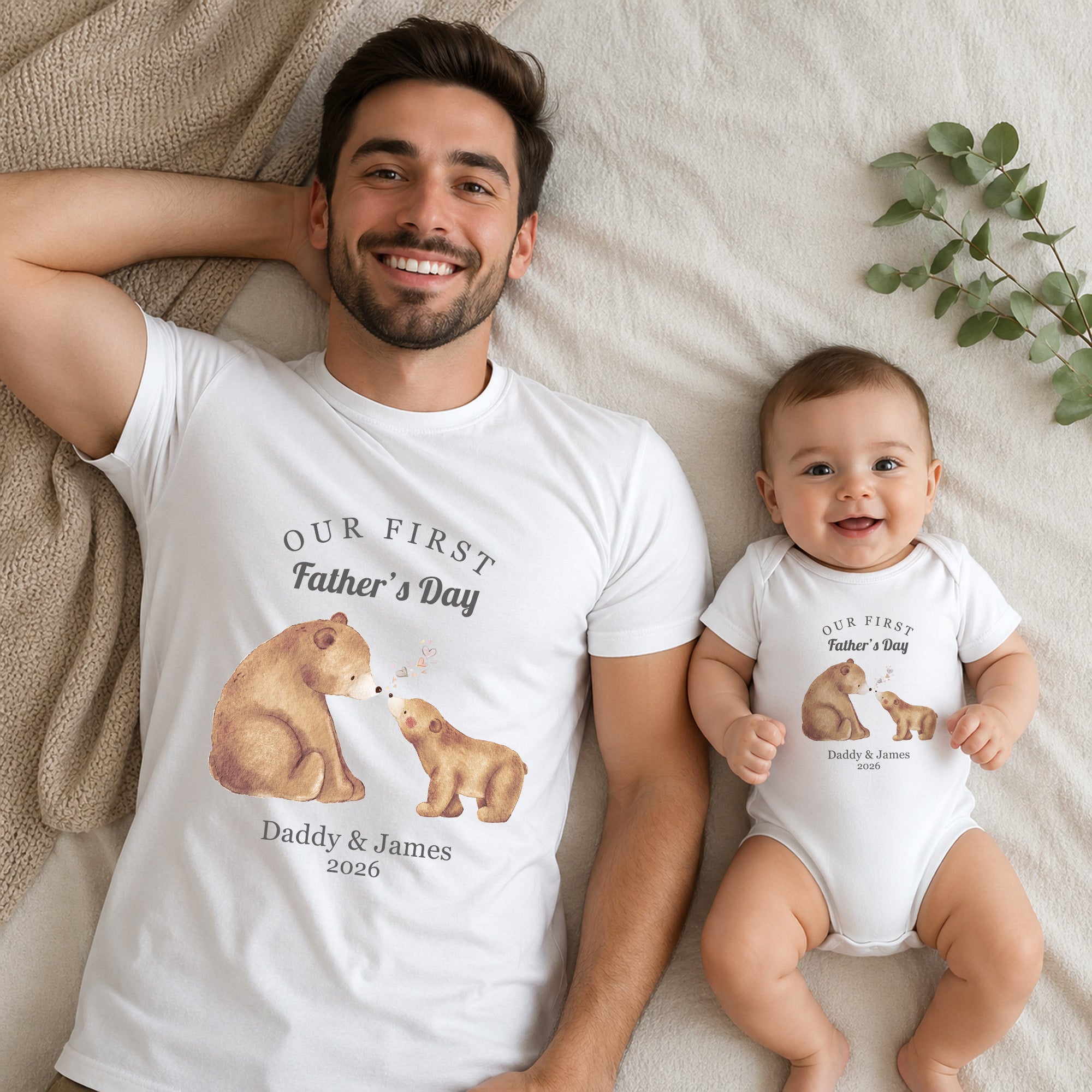 Dad and baby wearing matching Bear and Cub First Father’s Day outfits with personalised names and year.