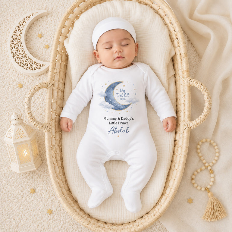 Baby wearing a personalised My First Eid baby grow with crescent moon Little Prince or Little Princess design on a cream Eid themed background.