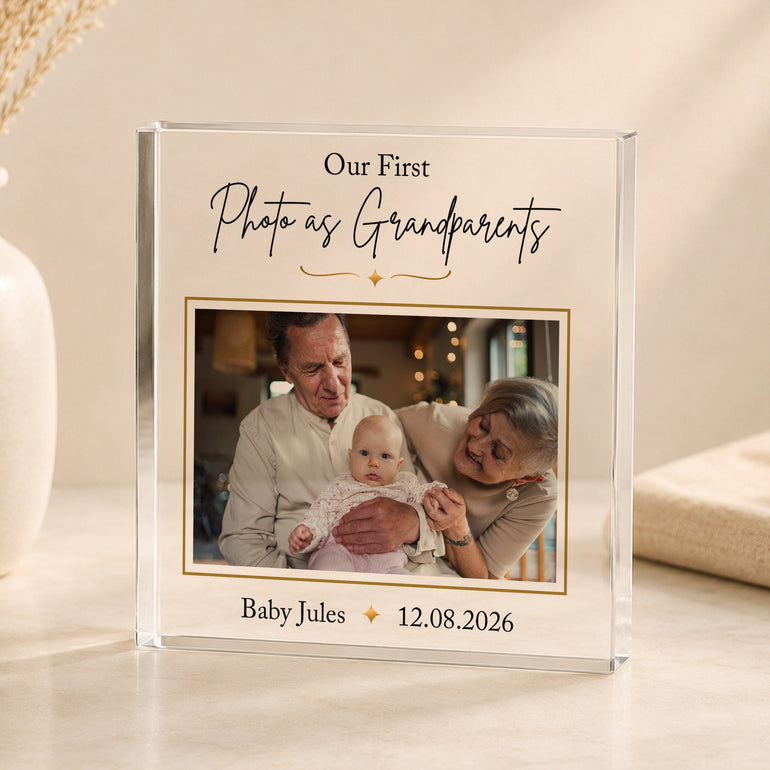Personalised grandparents first photo acrylic block featuring Grandma and Grandad holding their new grandchild with baby's name and date.