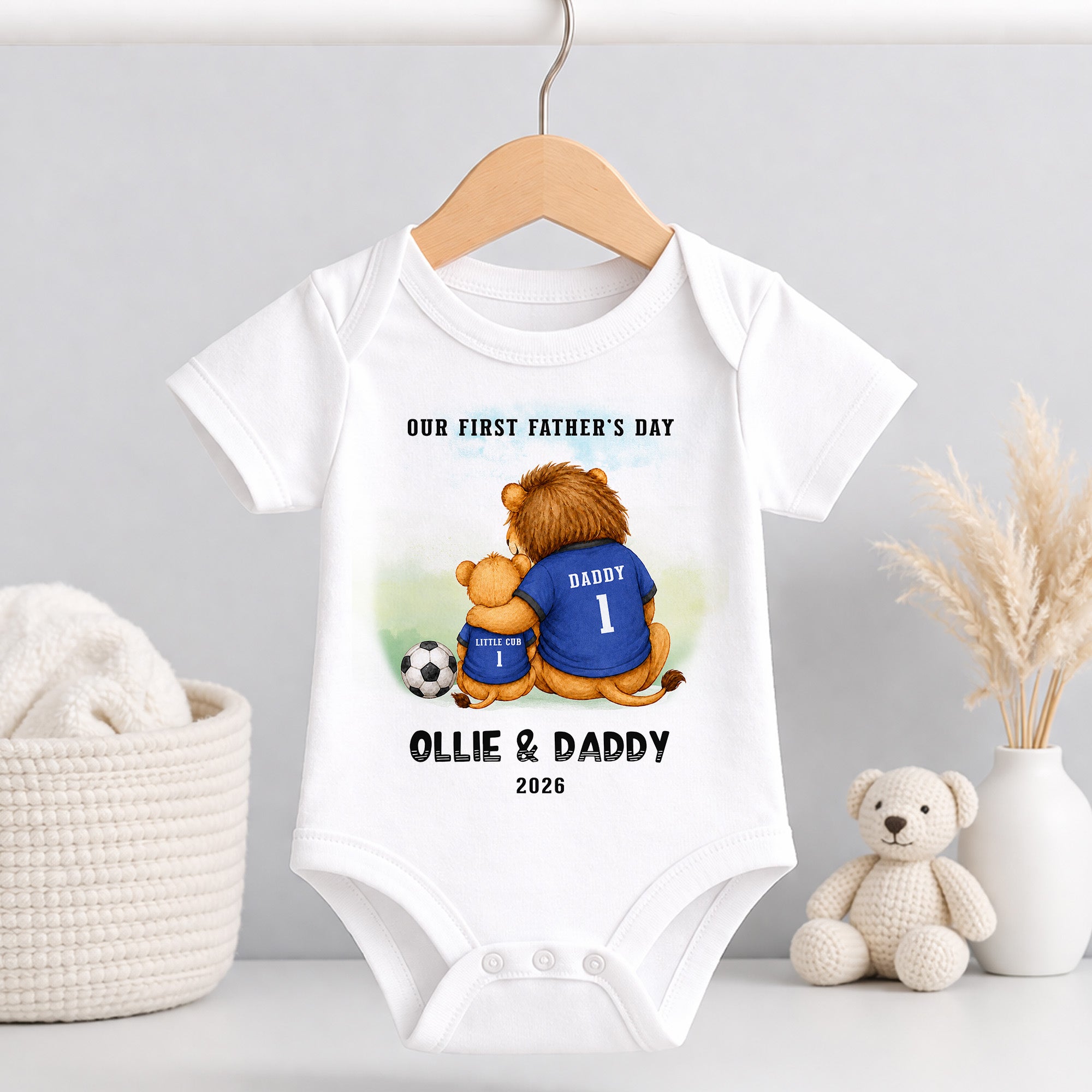 White personalised baby vest with First Father’s Day football lion design and custom Ollie and Daddy wording.
