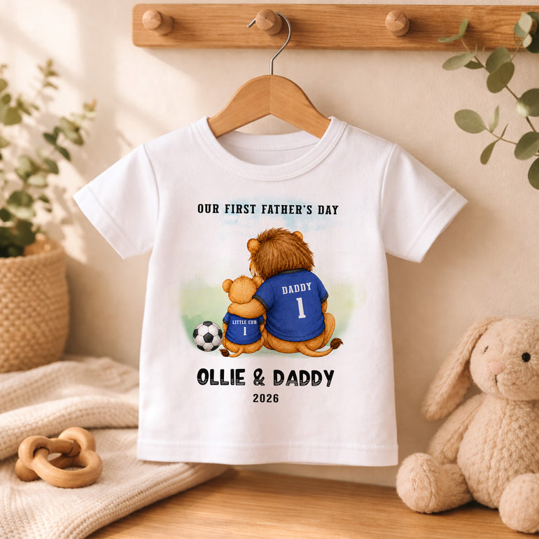 White kids T-shirt with football-themed First Father’s Day lion cub illustration and personalised name and year.