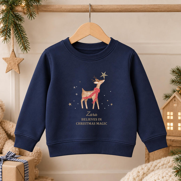 Navy kids reindeer Christmas jumper on a hanger with the reindeer and gold star design and gold lettering