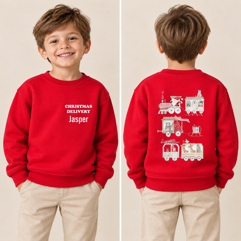 Boy shown front and back in a red kids train Christmas jumper, with his name on the front and the Santa train design on the back