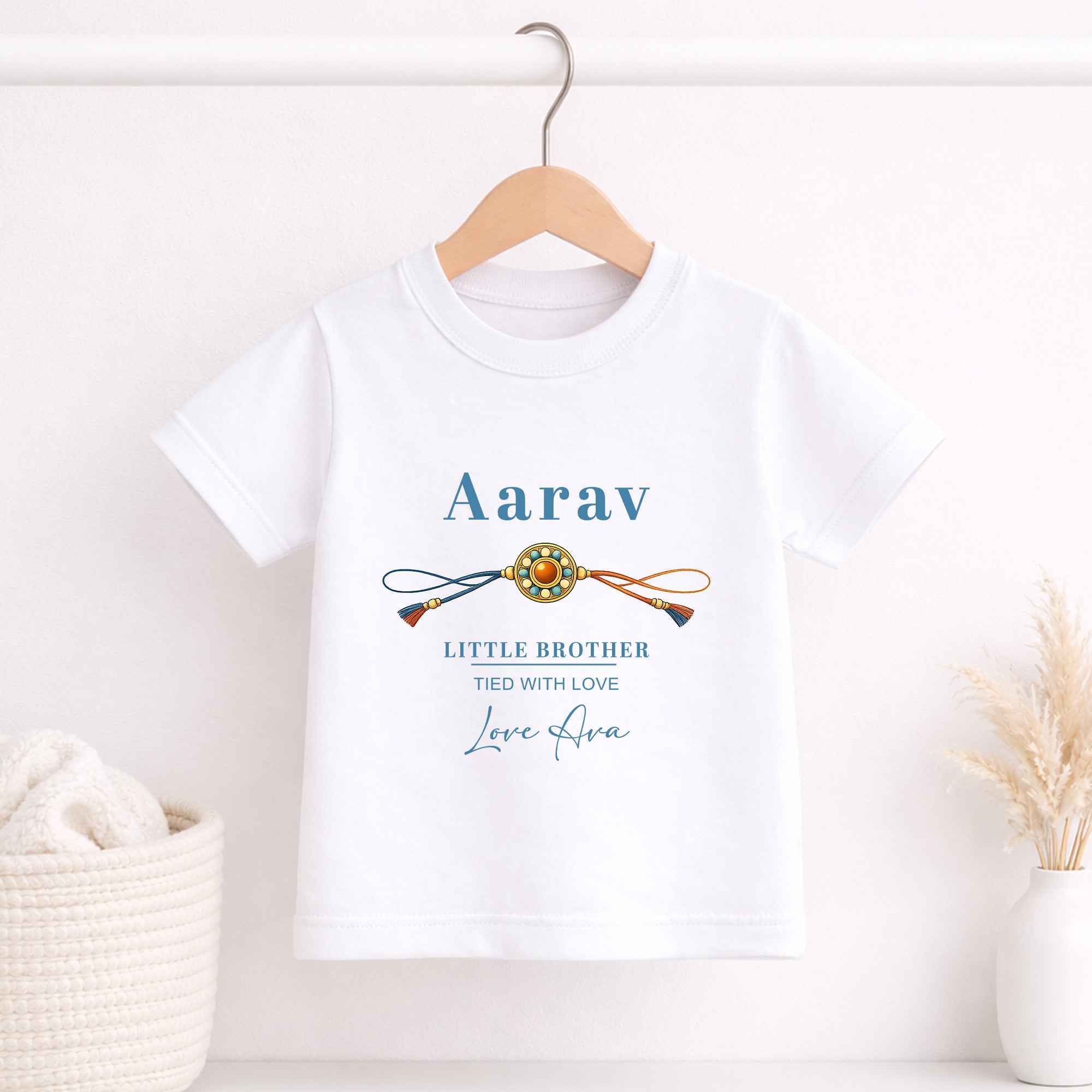 White children’s T-shirt personalised with Aarav, a traditional rakhi, Little Brother and Tied with Love wording.
