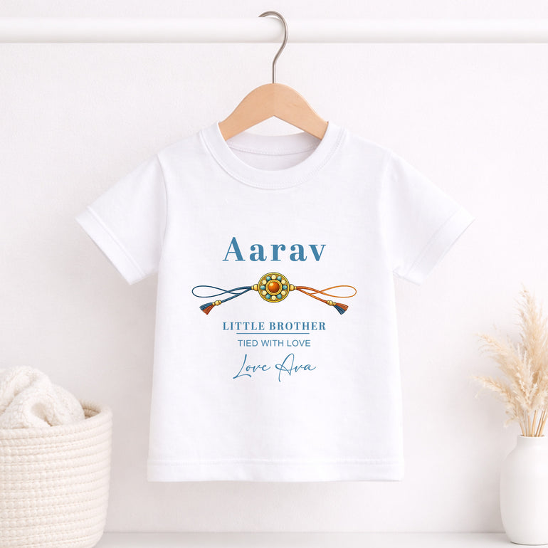 White children’s T-shirt personalised with Aarav, a traditional rakhi, Little Brother and Tied with Love wording.