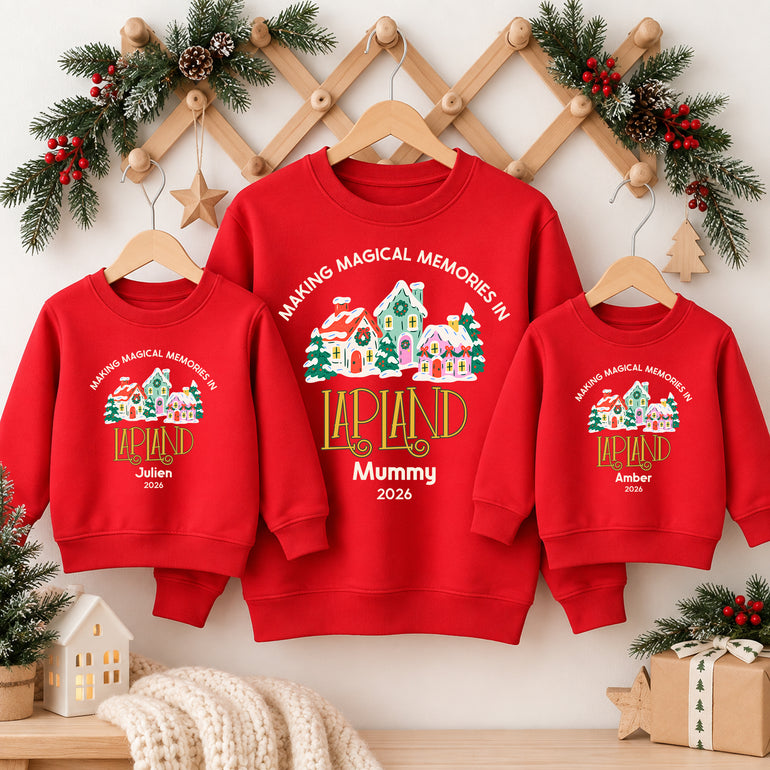 Family in red personalised Lapland jumpers reading Making Magical Memories in Lapland with the names Mummy, Julien and Amber and the year 2026