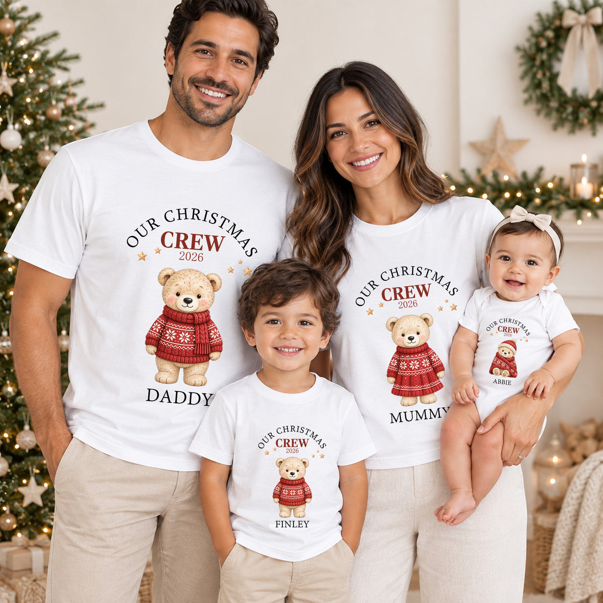 Family wearing personalised matching Christmas Crew T-shirts and baby clothing with festive teddy characters, names or family roles and custom year