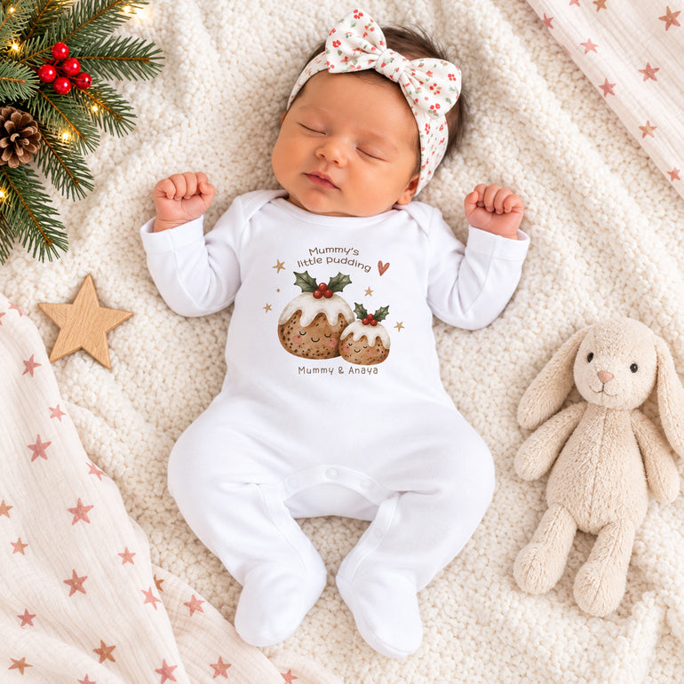 Newborn baby wearing personalised Mummy’s Little Pudding baby grow with Christmas pudding design and Mummy and child names