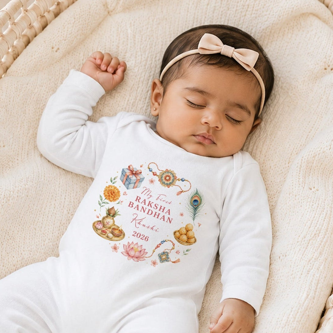 Sleeping baby girl wearing a personalised My First Raksha Bandhan baby grow with a colourful festival wreath.