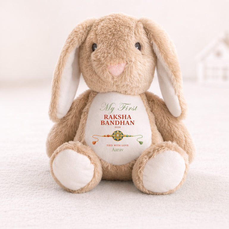 Neutral bunny personalised with My First Raksha Bandhan, the name Aarav, the year 2026 and a traditional rakhi.
